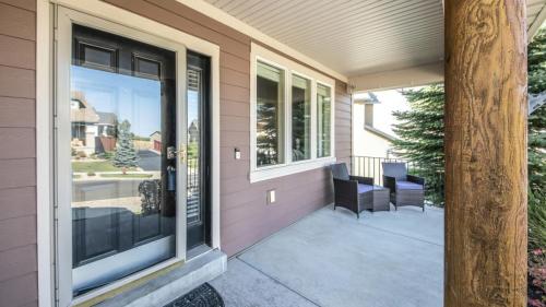 Pano Front porch of a house with engineered wood siding wall and log column post