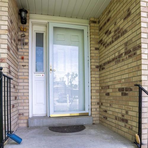 Square Front door of a house with bricks and metal railings
